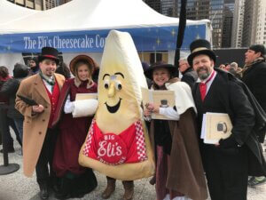 Eli's Slice Mascot and Carolers