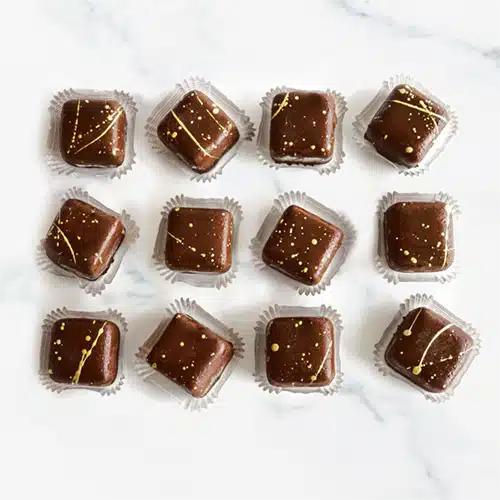 Bite-sized pieces of chocolate-covered cheesecakes
