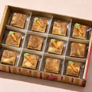 A box of bite-sized carrot cake cheesecake pieces
