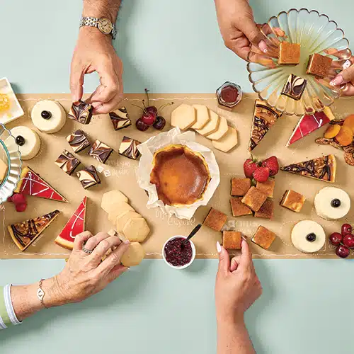 A cheesecake board with a variety of cheesecake shapes and sizes
