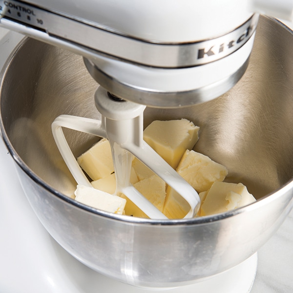 Cubes of butter in a mixer fitted with a paddle attachment