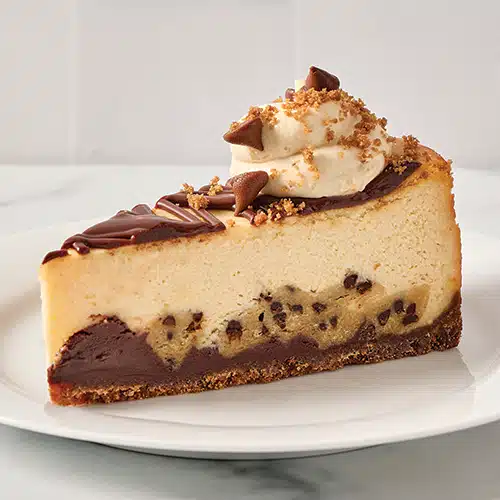 A slice of Cookie Dough Cheesecake on a plate
