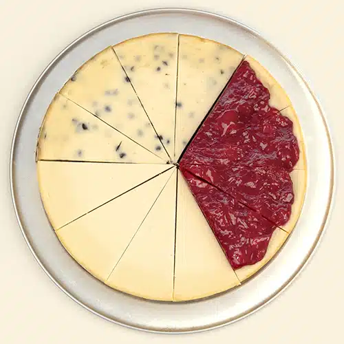 A sampler cheesecake with slices of Plain, Strawberry and Chocolate chip Cheesecakes